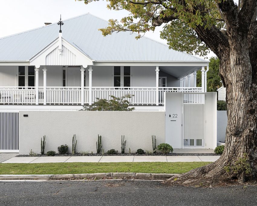 front of white home with white gated fence