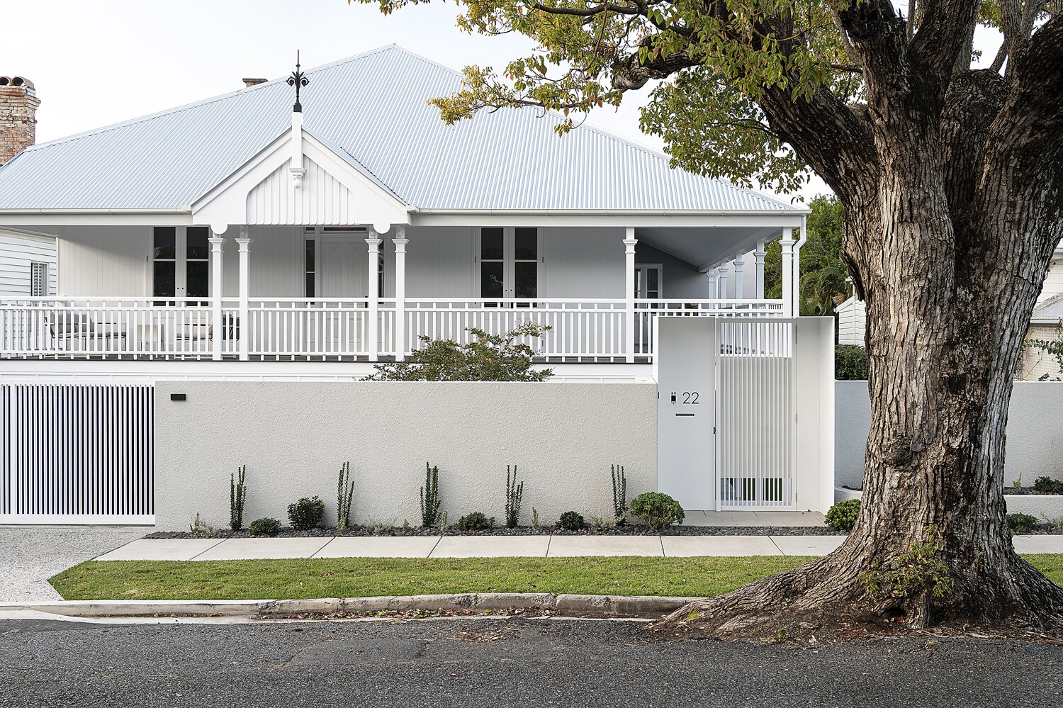 front of white home with white gated fence